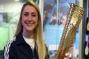 Dame Laura Kenny holding a London 2012 Olympic torch at the launch of the exhibition