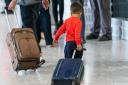 A young boy pulls a suitcase as refugees arrived from Afghanistan at Heathrow Airport