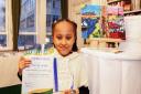 Hackney artist Chieyiem Nwigwe, 9, with her award and winning artwork, From Falmouth to London