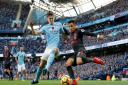Manchester City's John Stones (left) and Arsenal's Alexis Sanchez battle for the ball during the Premier League match at the Etihad Stadium, Manchester.