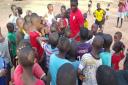 Priory Park coach Saidou Jarju meets a group of youngsters in his home town of Ziguinchor