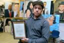Artist Kevin Gill at his studio in Leyton. Holding a letter from President Barack Obama sent in recognition of the painting he sent.