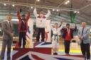 Tolga Gunes (centre) celebrates his gold medal on top of the podium