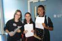 Laura Toulson (L), Lauren Hands (C) and Georgia Ludica-Davies (R), all 16, celebrate getting their GCSE results at Our Lady Convent School in Stamford Hill