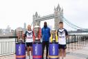 England Women\'s player Jodie Cunningham (left), rugby league legend Martin Offiah (centre) and England Wheelchair player Tom Halliwell (right) with the World Cup trophies near Tower Bridge to celebrate The National Lottery being the Official Partner of