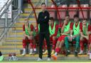 Leyton Orient head coach Richie Wellens looks on from the dugout