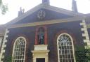 The statue of Sir Robert Geffrye features prominently on one side of the museum's building.