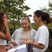 Myla Stiling, Georgia Julien and Amelie Noor celebrate their A Level results at The City Academy, Hackney, in Homerton Row