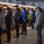 Passengers wearing face masks on a platform at Canning Town underground station in London. Picture: Victoria Jones/PA Images
