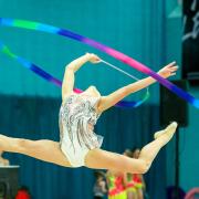 Rhythmic gymnasts performing at a competition