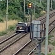 A black Land Rover Discovery sped onto railway tracks near Cheshunt during a police chase