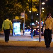 A woman walking after dark in London