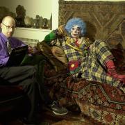 Dr Richard Wiseman (left), a psychologist, chats to a clown at the Freud Museum, as he sits on Sigmund Freud's infamous couch