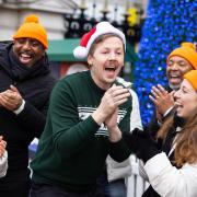 Hackney's Professor Green sings Christmas carols with a choir at London's Charing Cross station for the Just Eat Christmas Meal Appeal