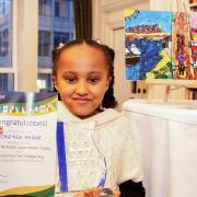 Hackney artist Chieyiem Nwigwe, 9, with her award and winning artwork, From Falmouth to London