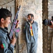 Bran Symondson captures an Afghan boy holding an AK-47 in 2010