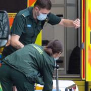 An ambulance crew load an empty bed onto an ambulance outside the Royal London Hospital, in London.