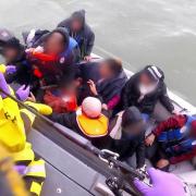 A Hackney man is running 100 half marathons for refugees. Pictured: A dinghy full of migrants being rescued by the RNLI in the English Channel.