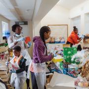 Hard working volunteers from Hackney charity Children With Voices sort supplies at one of its food hubs.