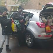 Students Lima Dias Fernandes Karen and Meya Holly help drop the collected food off at Hackney Foodbank.